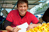 Photo showing a vendor behind his market stall